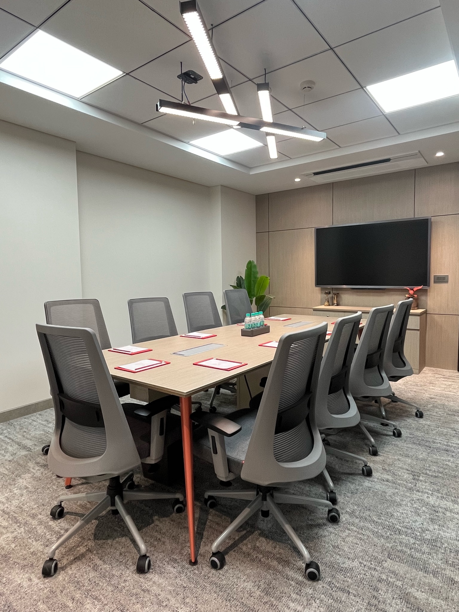 Meeting room with long table and wall-mounted display